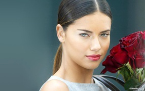 Adriana Lima with a bouquet of roses
