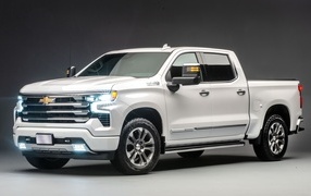 White expensive 2023 Chevrolet Silverado pickup truck on a gray background