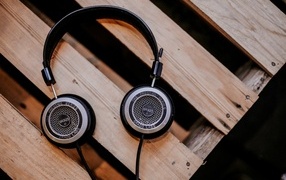 Old headphones lie on a wooden bench
