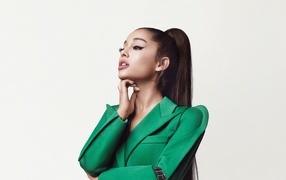 Singer Ariana Grande in a green suit