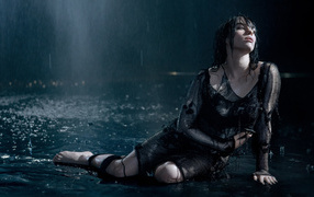 Singer Billie Eilish in a black dress in the rain