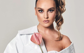 Singer Perrie Edwards holding a flower
