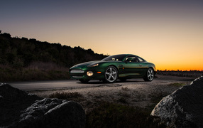 Aston Martin DB7 GT car against sunset background