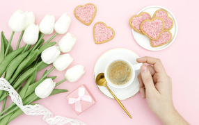 Bouquet of white tulips with a cup of coffee and cookies for your beloved