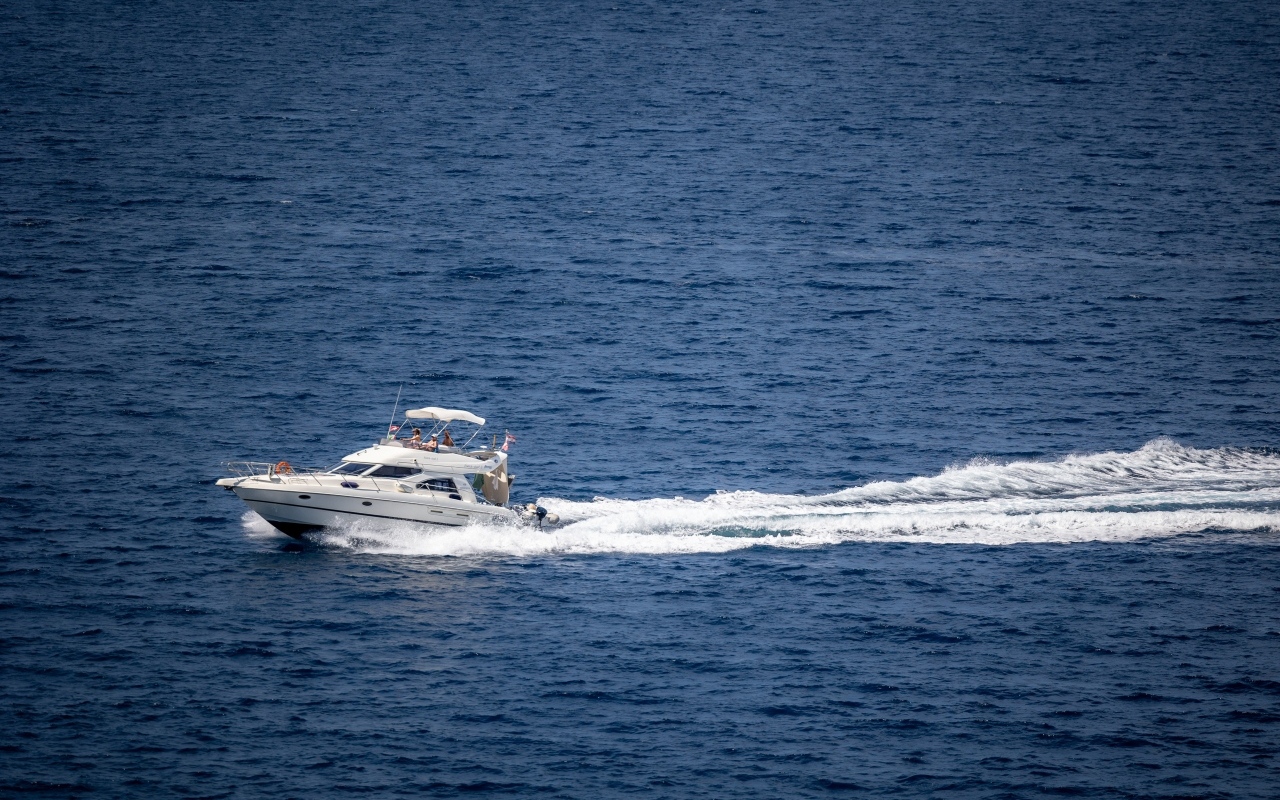 Fast white yacht at sea
