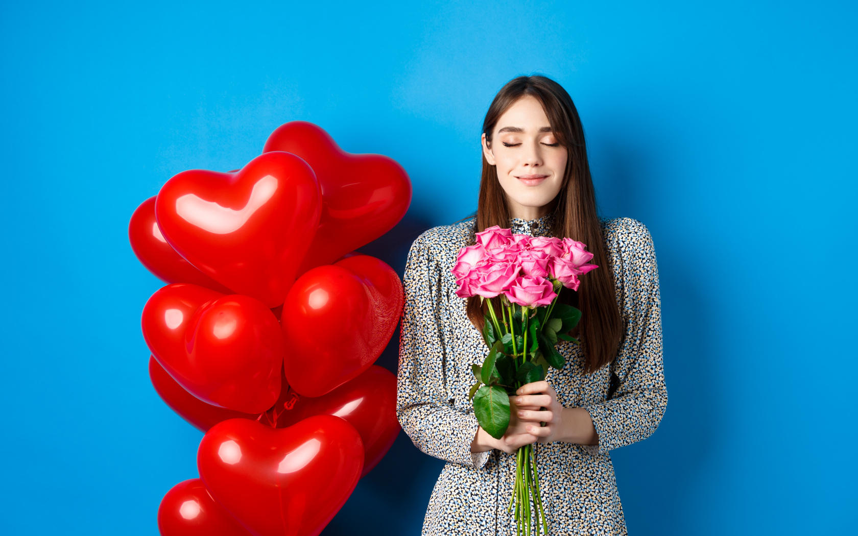 Girl with a bouquet of roses and balloons for Valentine's Day