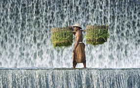 Farmer with baskets is a waterfall