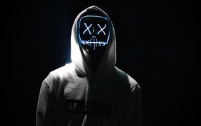 Glowing mask on the face of a guy in the hoodie