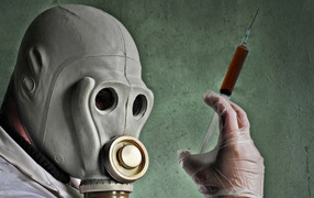 Мужчина в противогазе со шприцем в руках, пандемия коронавирус