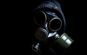 Guy in a gas mask on a black background, coronavirus pandemic