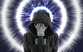 Young guy in a black jacket in a gas mask during a pandemic