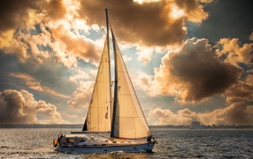 Large sailing yacht at sea at sunset