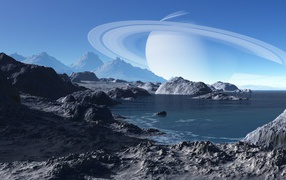 Large planet Saturn over water with mountains