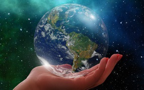 Planet earth lies on the hand