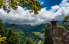 Красивый вид на покрытые зеленью гор под густыми облаками, Япония