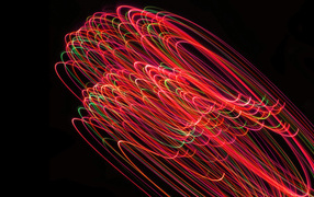 Bright light waves in motion on a black background