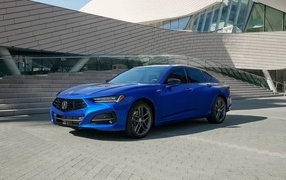 Blue 2024 Acura TLX A-Spec car in front of a building