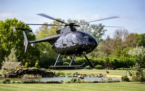 Gray helicopter takes off from the ground