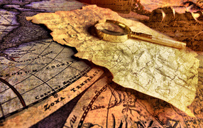 Лупа и старая карта на столе