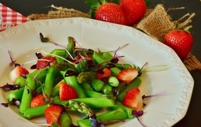 Asparagus in a plate with strawberries