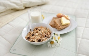 Cereals with milk and bread on the table