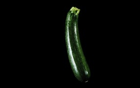 Green zucchini on a black background