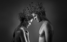 Plants on the head of a man and woman on a gray background