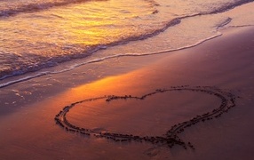Big heart on the sand by the sea