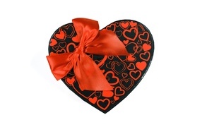 Large heart-shaped box with a red bow on a white background
