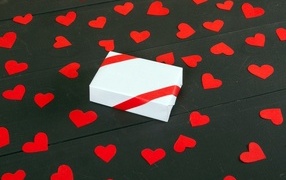 White box with small paper hearts on the table