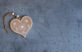 Wooden heart on a string on a gray background