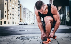 Male athlete tying his shoelaces
