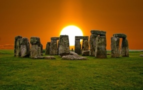 Stone structure Stonehenge against the background of the sun