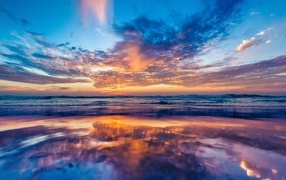 Beautiful sky reflected in sea water at dawn