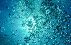 Bubbles in blue water in the sun