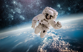 Astronaut flies over planet earth in space