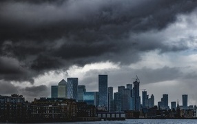 Black clouds over city skyscrapers