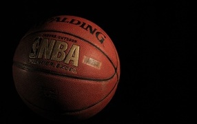 Leather basketball ball on black background