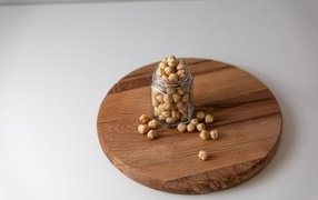 Nuts in a jar on a wooden board