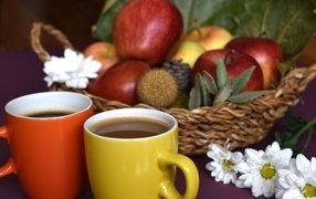 Two cups of coffee on the table with fruits