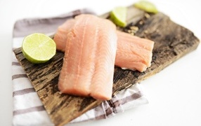 Pieces of fish on the table with lime