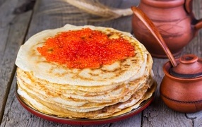Appetizing pancakes with red caviar on the table for Maslenitsa