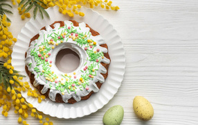 Beautiful Easter cake with mimosa branch and eggs