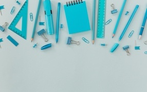 Blue stationery items on a blue background