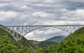 View of a steel viaduct over green-covered mountains
