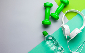 Dumbbells, bottle of water and headphones