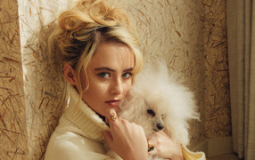 Actress Kathryn Newton with a dog near the wall