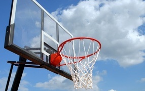 Basketball hoop against a background of white clouds