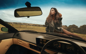 Beautiful Victoria Beckham sits on a car