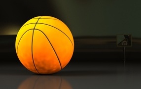 Большой оранжевый мяч на сером фоне